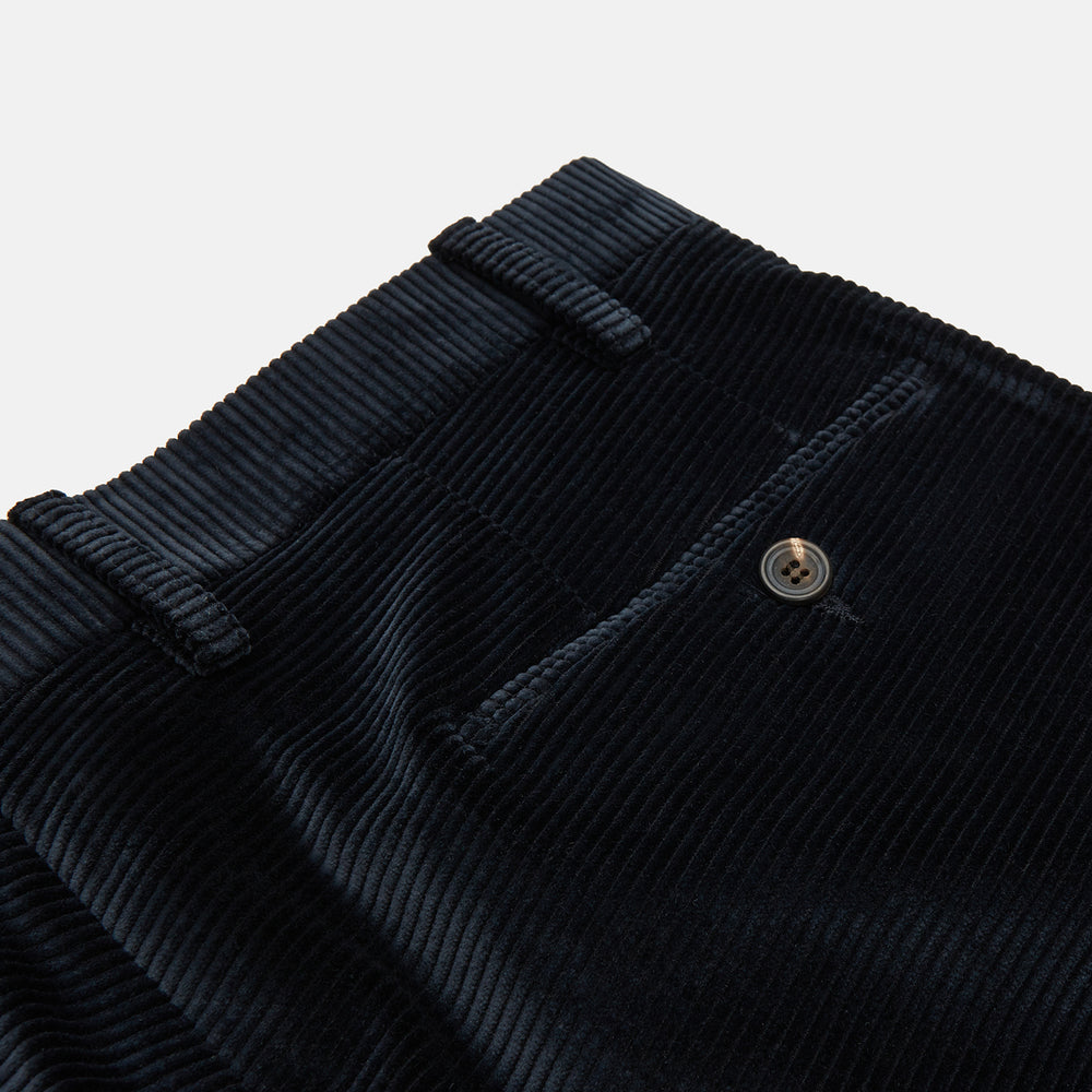 Turnbull & Asser Navy Horizontal Cord Trousers in pure cotton feature a straight-leg fit, side pockets, and button closure, shown against a plain light gray background.