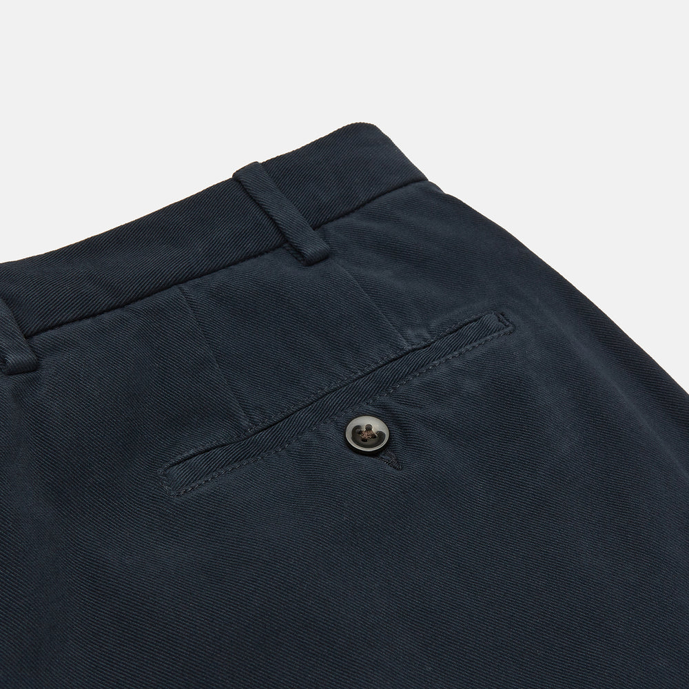 Turnbull & Asser Navy Cotton Chinos—plain, straight-leg trousers with button closure and belt loops, tailored in Italy and featured against a white background.