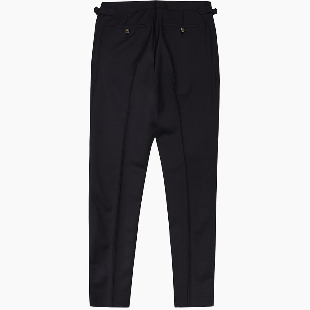 A pair of navy Escorial wool trousers by Turnbull & Asser, featuring a tailored style, straight-leg fit, front crease, belt loops, side pockets, and metal buckle details on the waistband, shown against a white background.