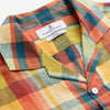 View 4 of product Turnbull & Asser's Orange Madras Check Holiday Fit Long Sleeve Linen Shirt features a bold plaid in orange, yellow, green, and blue with a revere collar and 1-button cuff—ideal for effortless holiday style. Laid flat on white background.