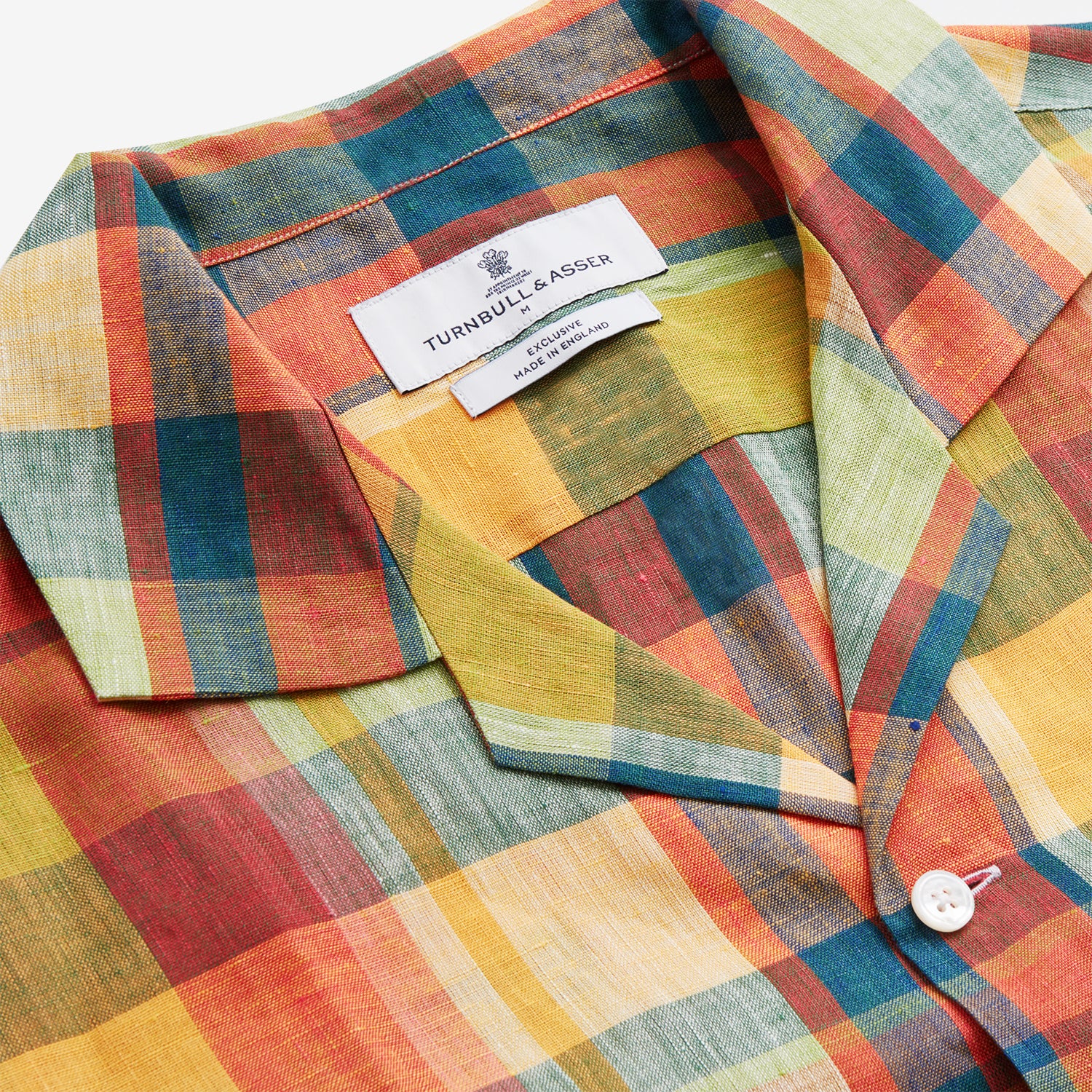 View 4 of product Turnbull & Asser's Orange Madras Check Holiday Fit Long Sleeve Linen Shirt features a bold plaid in orange, yellow, green, and blue with a revere collar and 1-button cuff—ideal for effortless holiday style. Laid flat on white background.
