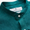 View 4 of product The Turnbull & Asser Teal Weekend Fit Long Sleeve Linen Shirt features a stand collar, 1-button cuffs, white buttons, and a relaxed fit, shown on a plain white background.