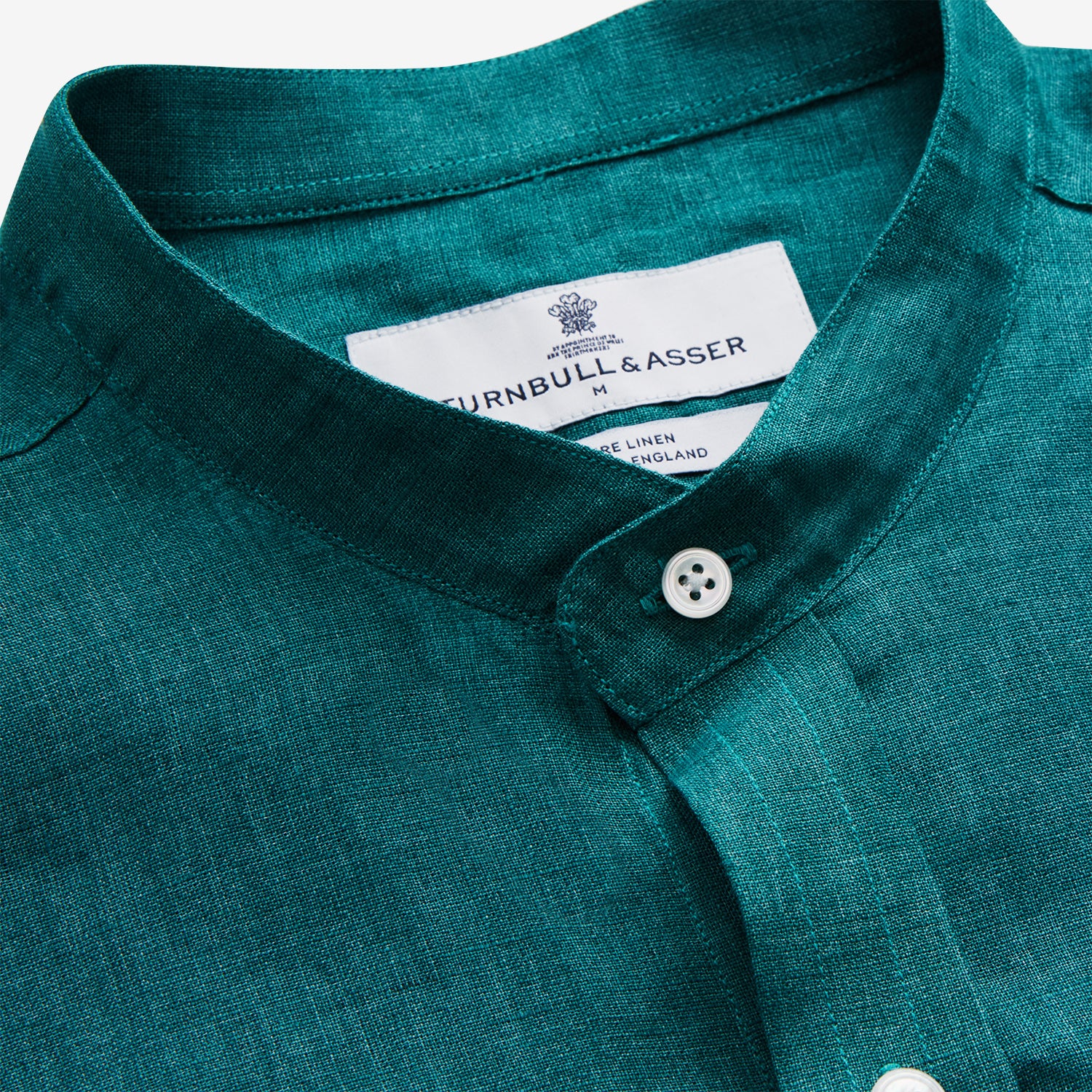 View 4 of product The Turnbull & Asser Teal Weekend Fit Long Sleeve Linen Shirt features a stand collar, 1-button cuffs, white buttons, and a relaxed fit, shown on a plain white background.