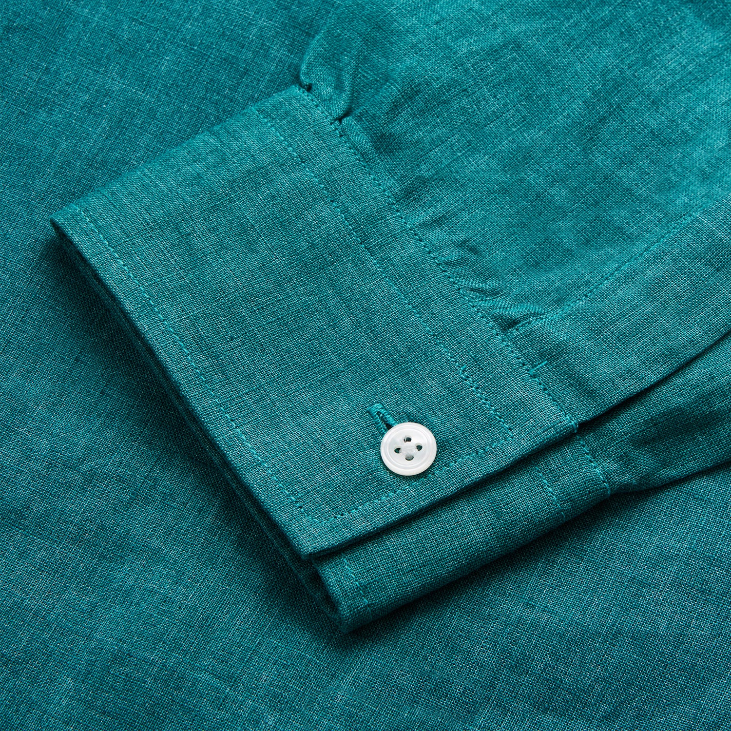 View 3 of product The Turnbull & Asser Teal Weekend Fit Long Sleeve Linen Shirt features a stand collar, 1-button cuffs, white buttons, and a relaxed fit, shown on a plain white background.