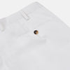 View 4 of product Turnbull & Asser’s White Cotton Pleated Trousers, a summer classic, are elegantly displayed against a crisp white backdrop.