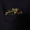 View 2 of product The Tan Medallion Print Silk Pocket Square by Turnbull & Asser features an elegant medallion geometric pattern in blue, white, and gold with central diamond shapes and a gold dotted border on luxurious silk.