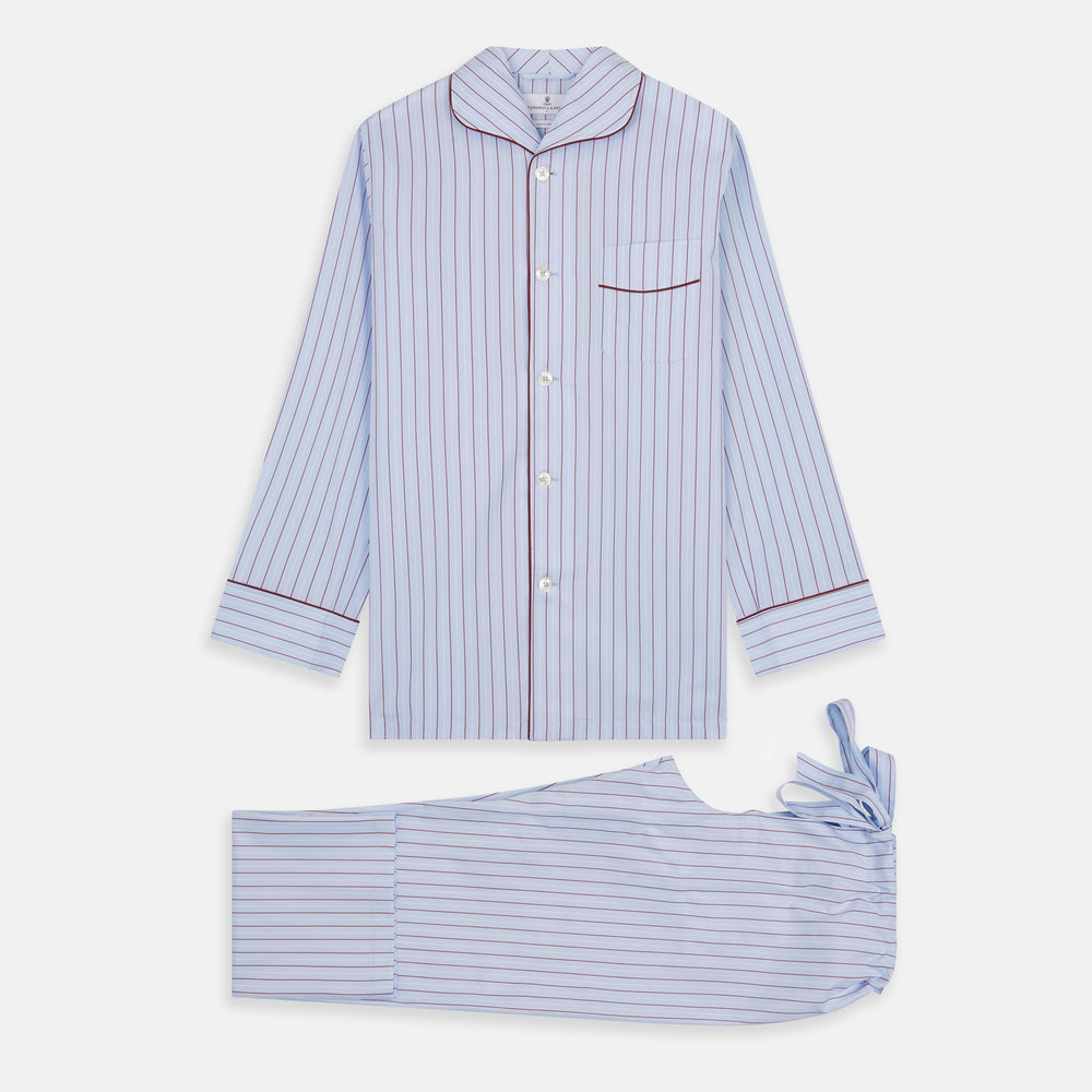 The Turnbull & Asser Burgundy Stripe Classic Pyjama Set features long sleeves, a button-up top with red piping, matching drawstring pants, and a traditional fit. Laid flat, it's luxury loungewear in signature burgundy stripes.