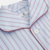 View 2 of product The Turnbull & Asser Burgundy Stripe Classic Pyjama Set features long sleeves, a button-up top with red piping, matching drawstring pants, and a traditional fit. Laid flat, it's luxury loungewear in signature burgundy stripes.