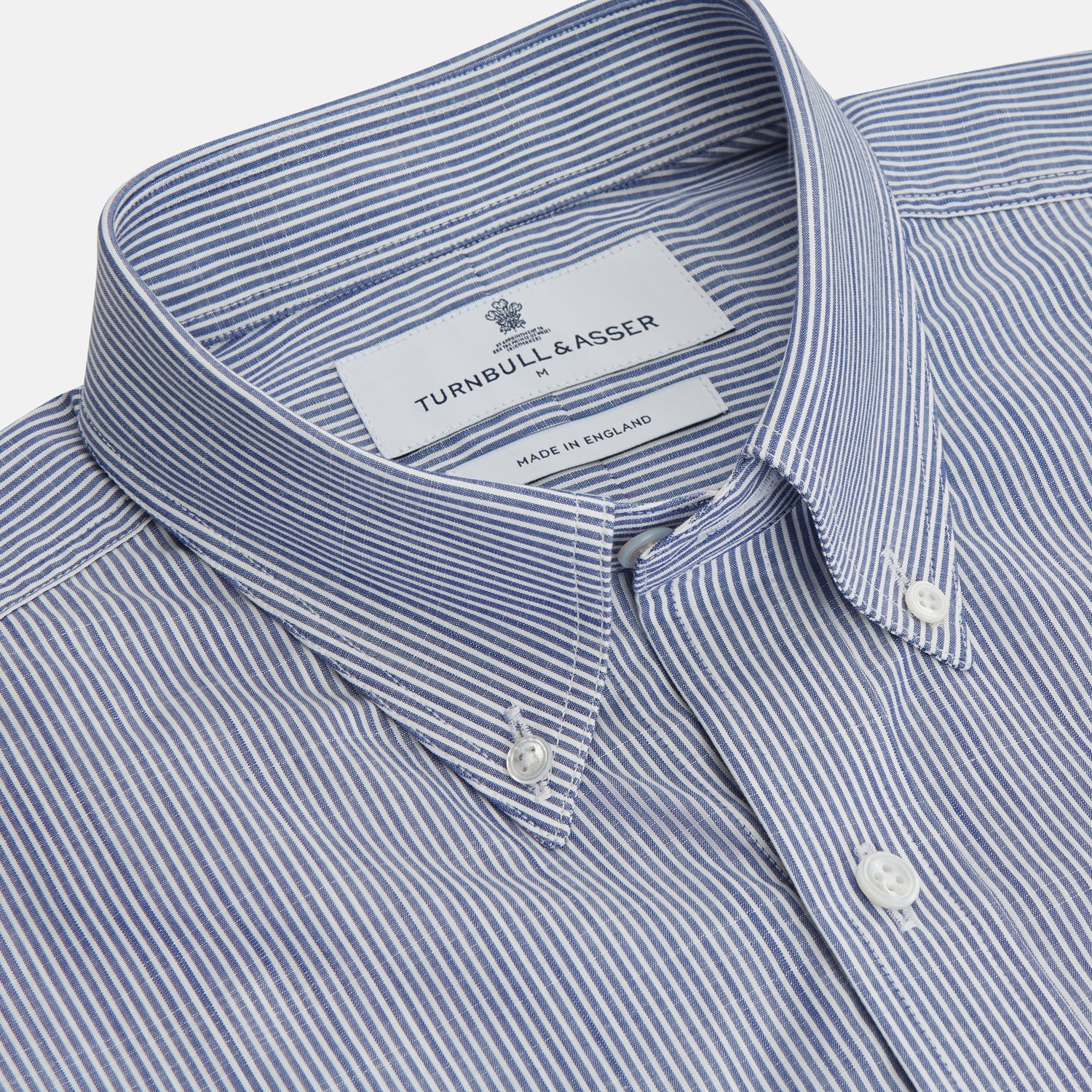 View 2 of product Turnbull & Asser’s Indigo Chambray Stripe Weekend Fit Shirt with Dorset collar features thin white pinstripes, two button-flap chest pockets, buttoned cuffs, and relaxed styling—presented flat on a white background.