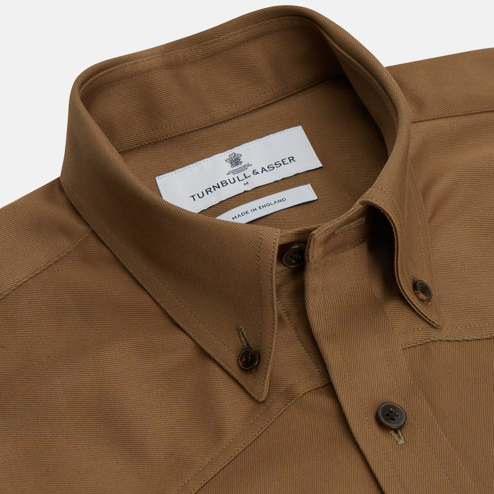 The Turnbull & Asser Khaki Cotton Weekend Fit Western Shirt features a Dorset collar, long sleeves, two button-flap chest pockets, and buttoned cuffs—an essential smart-casual piece shown against a white background.
