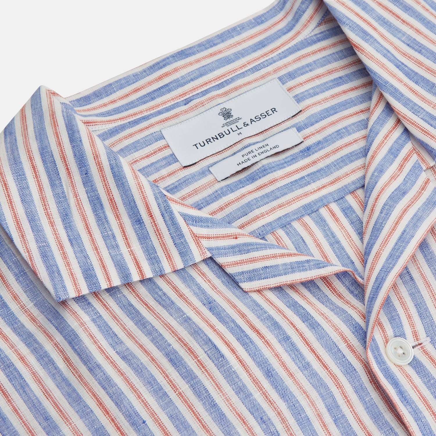 View 3 of product The Turnbull & Asser Blue and Red Linen Stripe Holiday Fit Shirt features a revere collar, relaxed fit, and short sleeves—perfect resort wear with vertical blue, white, and light red stripes.