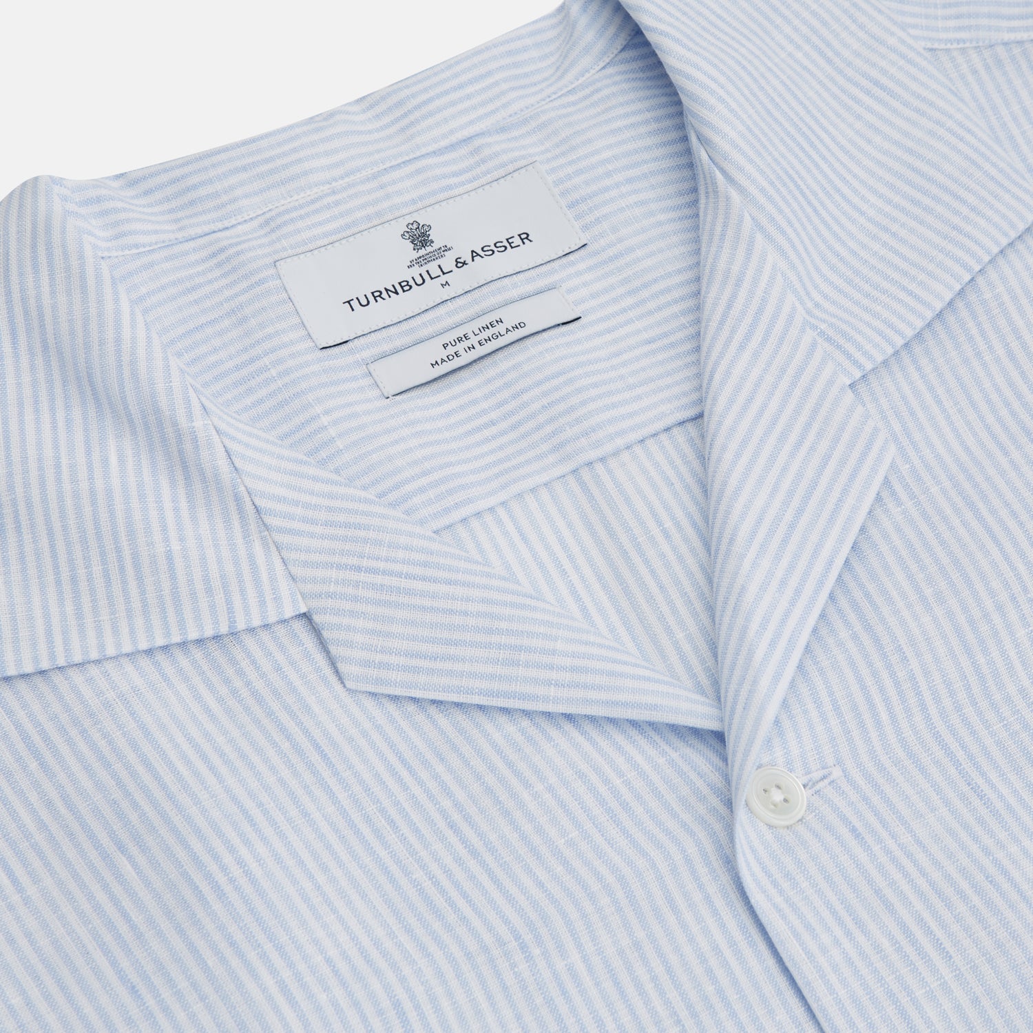 View 2 of product The Turnbull & Asser Blue Linen Stripe Holiday Fit Shirt features short sleeves, a revere collar, and single chest pocket, perfect for resort wear. Shown on a plain white background.