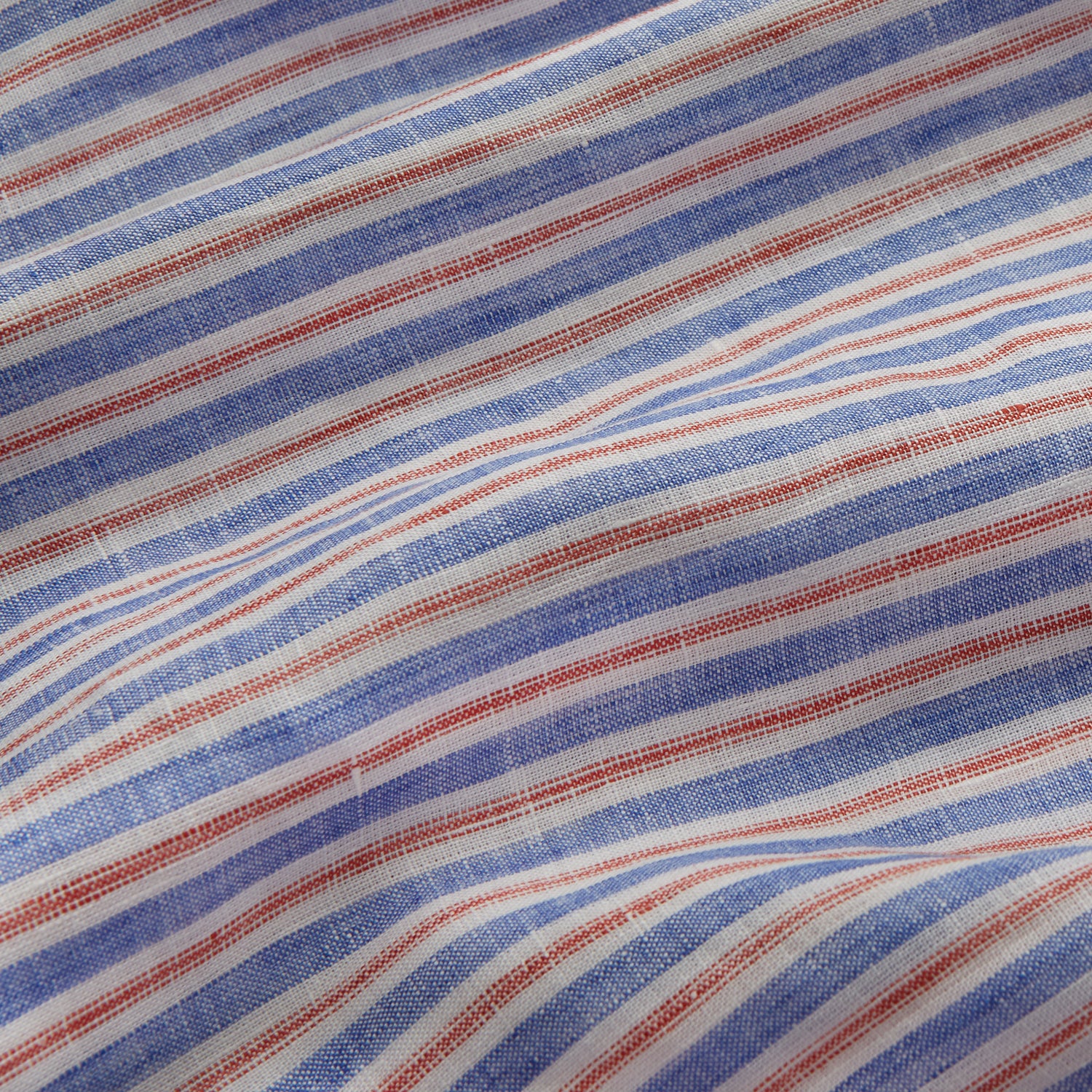 View 2 of product The Turnbull & Asser Blue and Red Linen Stripe Holiday Fit Shirt features a revere collar, relaxed fit, and short sleeves—perfect resort wear with vertical blue, white, and light red stripes.