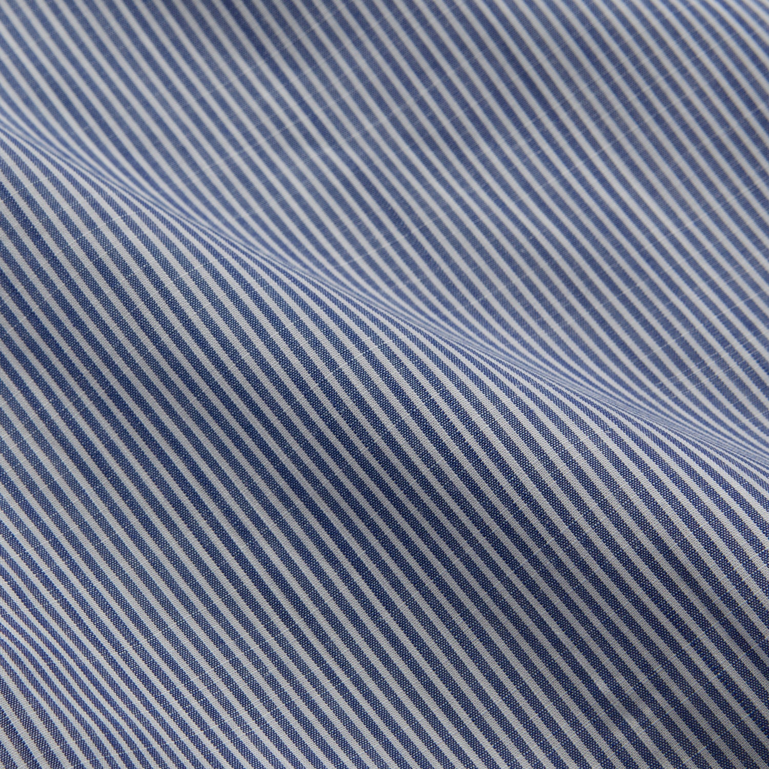 View 4 of product Turnbull & Asser’s Indigo Chambray Stripe Weekend Fit Shirt with Dorset collar features thin white pinstripes, two button-flap chest pockets, buttoned cuffs, and relaxed styling—presented flat on a white background.