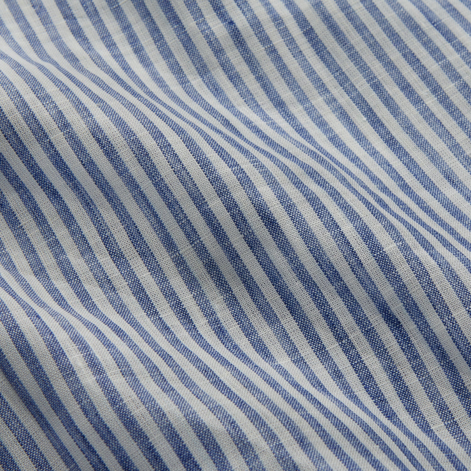 View 2 of product The Turnbull & Asser Sky Blue Linen Stripe Weekend Fit Shirt features blue and white vertical stripes, a Derby collar, and buttoned cuffs—ideal for pairing with classic cotton suits or other Weekend Fit shirts.