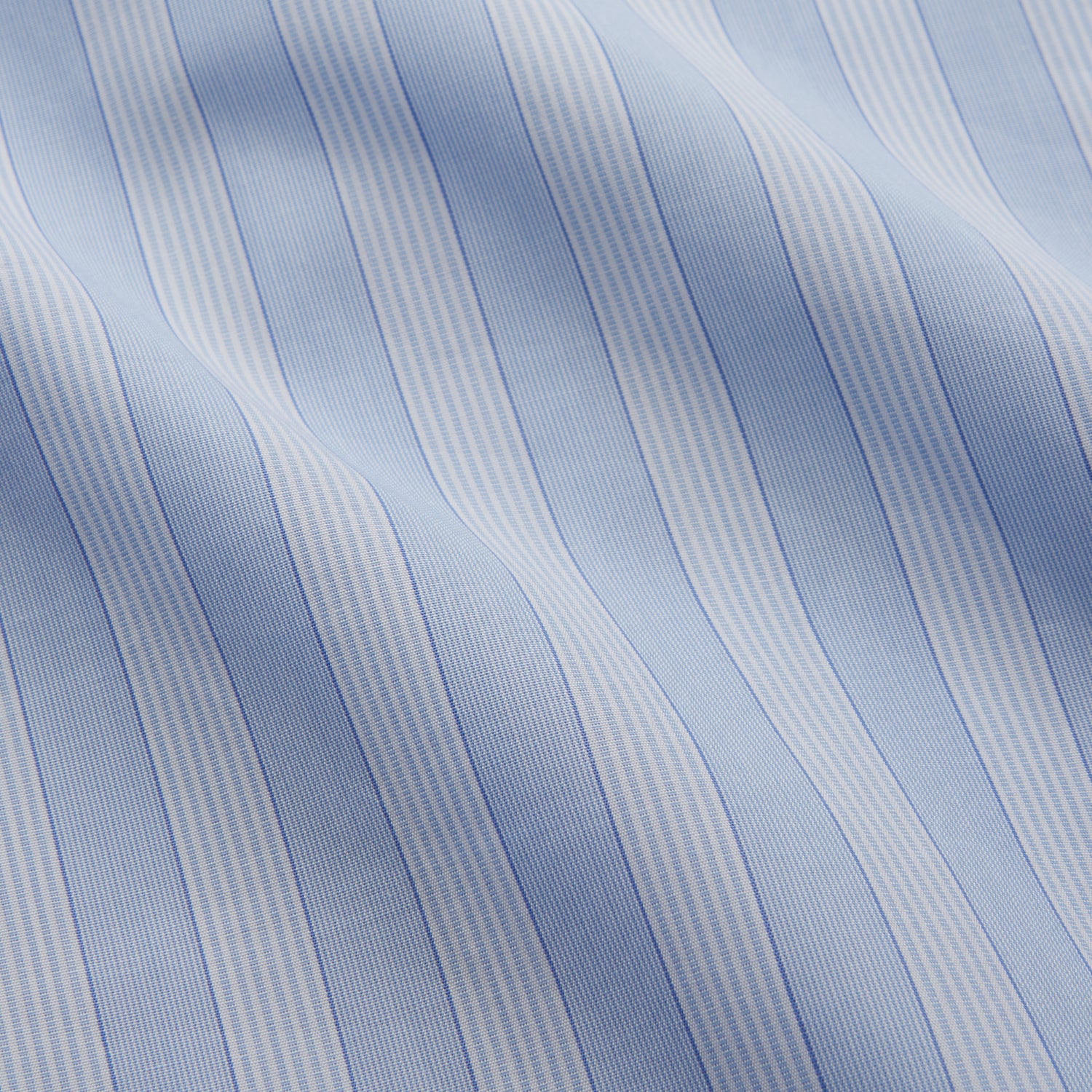View 4 of product The Turnbull & Asser Tonal Blue Stripe Tailored Fit Shirt with Kent Collar features long sleeves and a button-up front, shown laid flat against a white background.