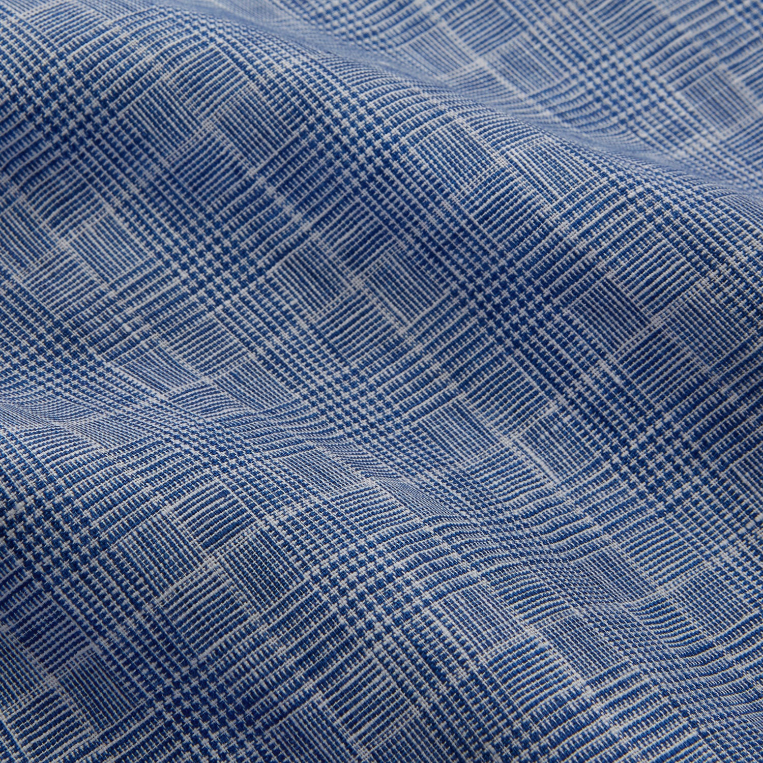 View 5 of product The Indigo Linen Glen Check Weekend Fit Shirt with Derby Collar by Turnbull & Asser is a light blue, long-sleeve checked linen shirt, featuring a subtle white plaid pattern and shown against a plain white background.