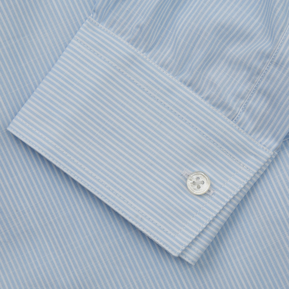 The Turnbull & Asser Sky Blue Chambray Stripe Weekend Fit Shirt features a Dorset collar, long sleeves, and two button-flap chest pockets, offering a relaxed look. Displayed on a plain white background.