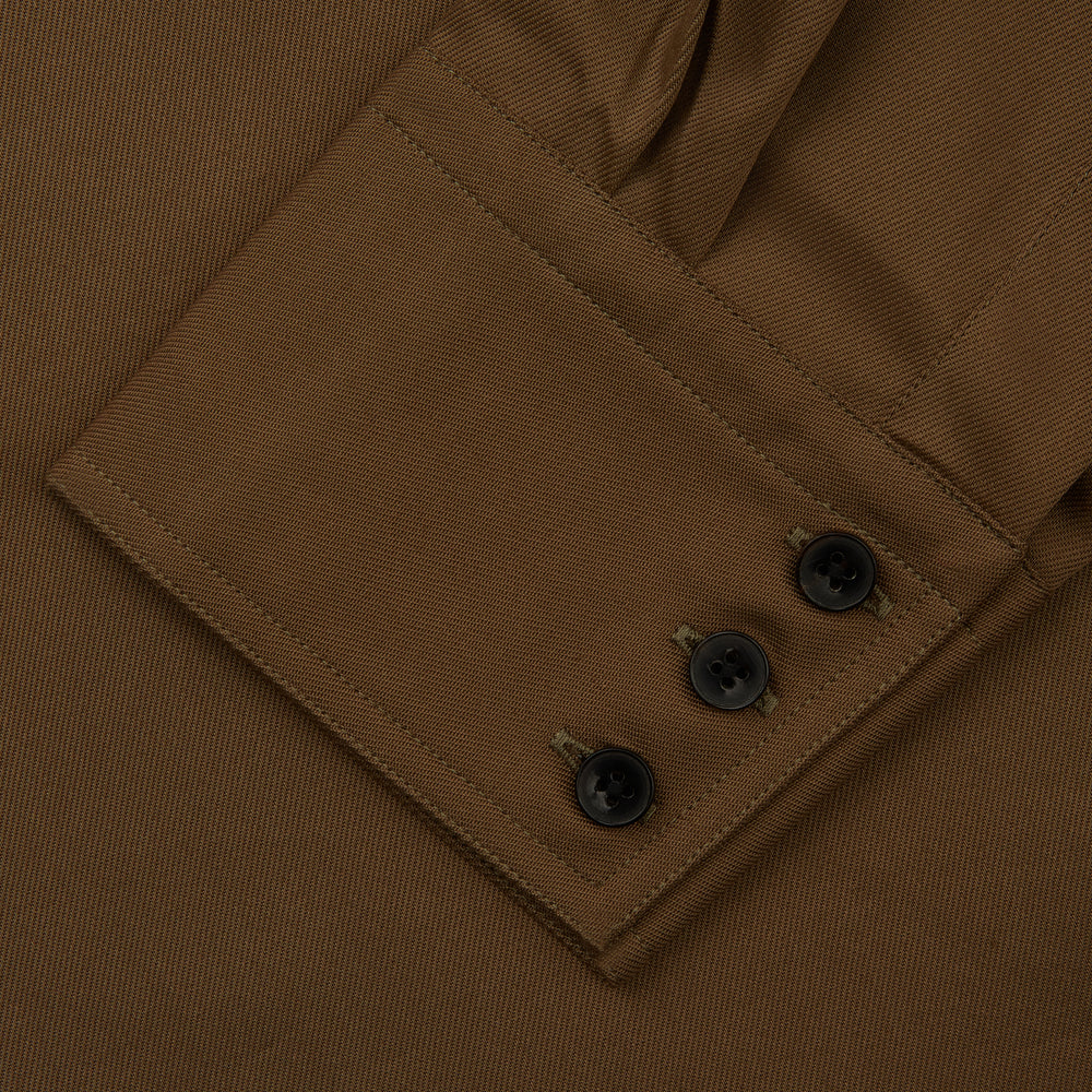 The Turnbull & Asser Khaki Cotton Weekend Fit Western Shirt features a Dorset collar, long sleeves, two button-flap chest pockets, and buttoned cuffs—an essential smart-casual piece shown against a white background.