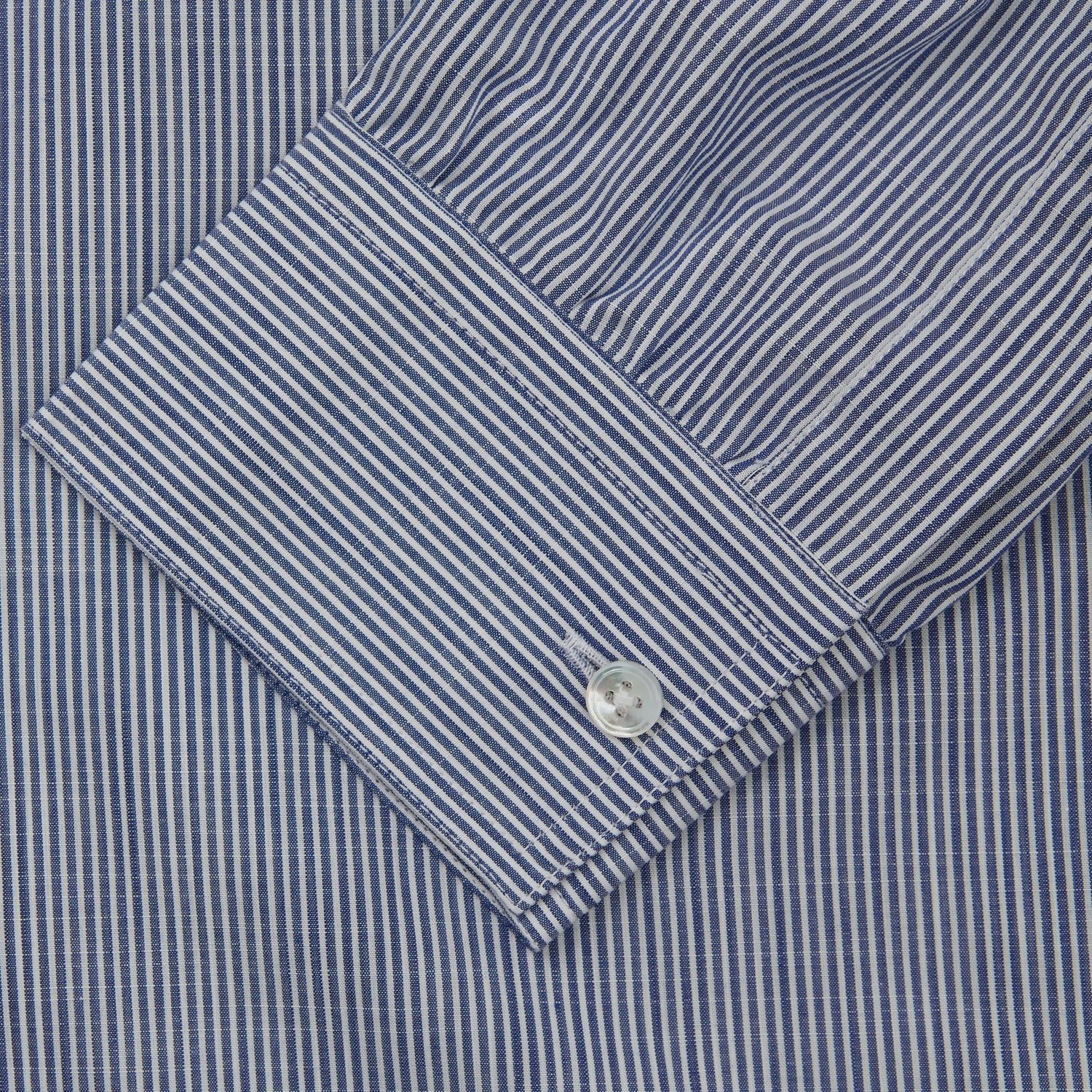 View 3 of product Turnbull & Asser’s Indigo Chambray Stripe Weekend Fit Shirt with Dorset collar features thin white pinstripes, two button-flap chest pockets, buttoned cuffs, and relaxed styling—presented flat on a white background.