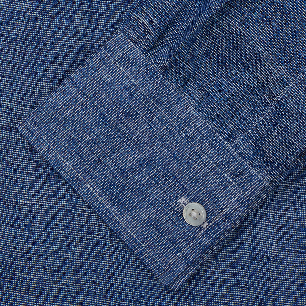 The Indigo Linen Weekend Fit Shirt with Derby Collar by Turnbull & Asser, shown flat on a white background, features long sleeves, white buttons, and buttoned cuffs—ideal for pairing with a classic suit or for casual wear.