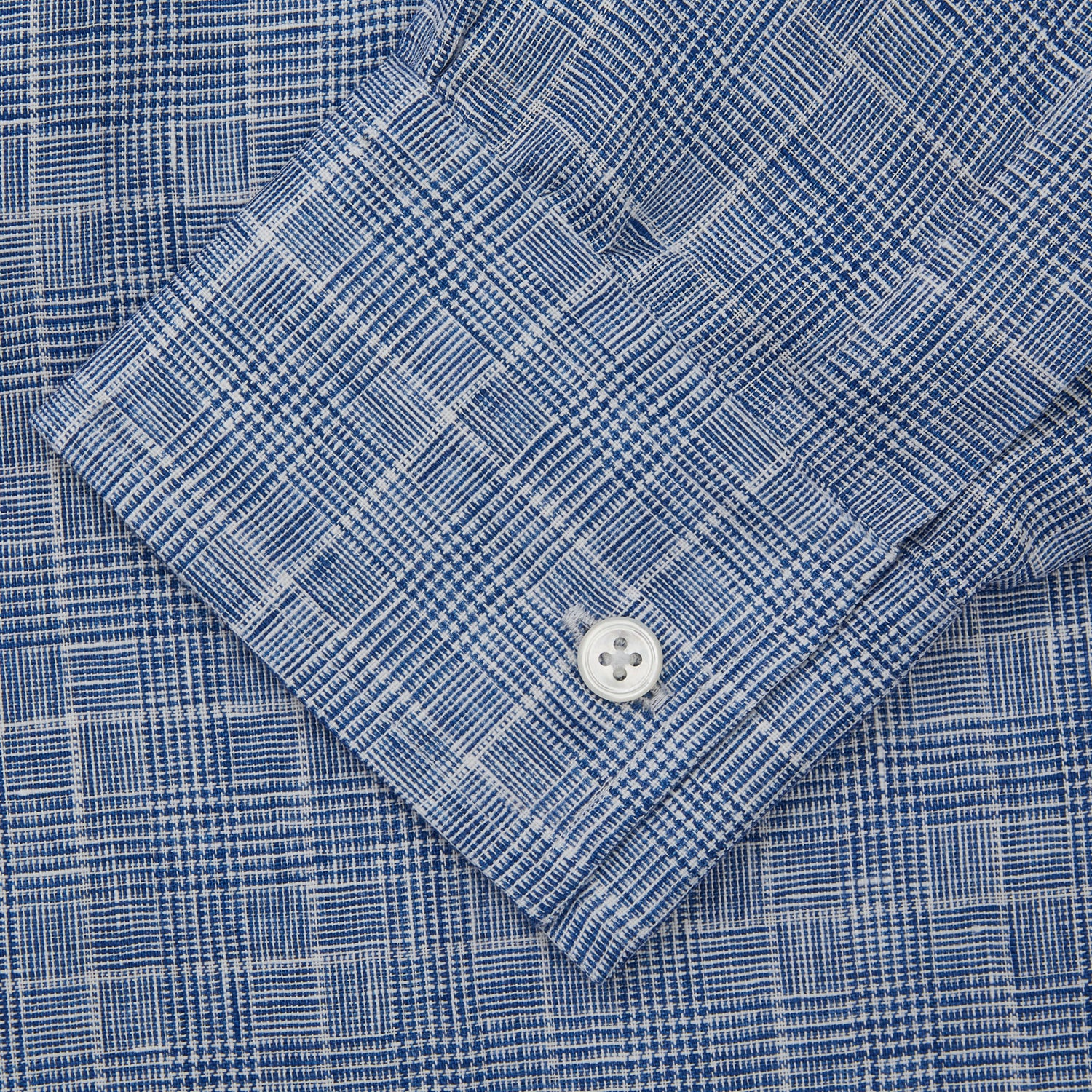 View 4 of product The Indigo Linen Glen Check Weekend Fit Shirt with Derby Collar by Turnbull & Asser is a light blue, long-sleeve checked linen shirt, featuring a subtle white plaid pattern and shown against a plain white background.