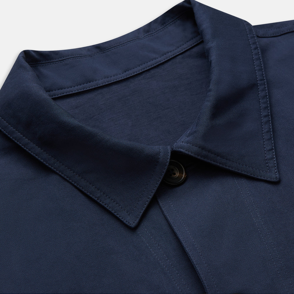 The Turnbull & Asser Navy Cotton-Linen Remy Chore Jacket features a collar, long sleeves, button closure, and three front pockets—a versatile minimalist essential for any men's wardrobe, shown laid flat on a white background.