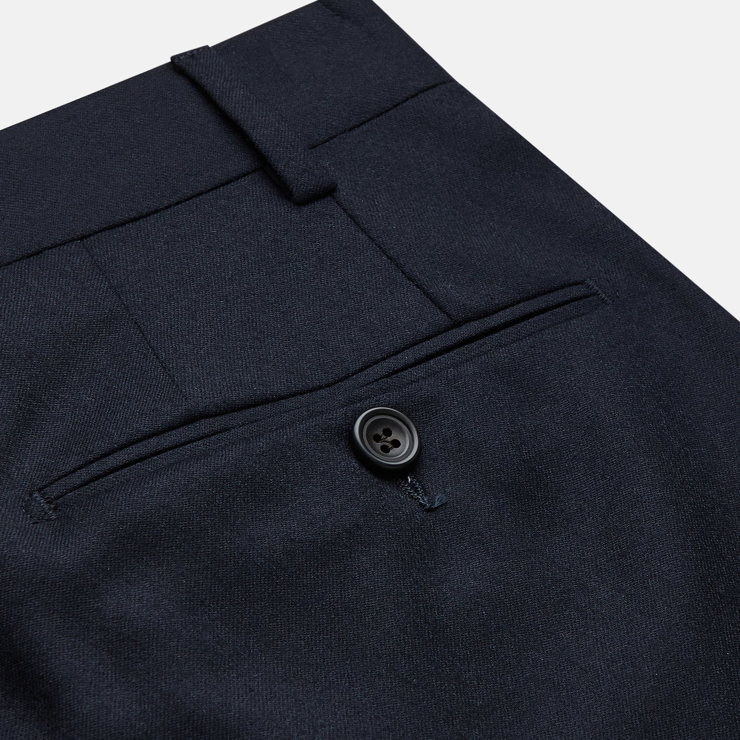 View 2 of product The Navy Wool Pleated Jasper Trouser by Turnbull & Asser features lightweight wool, a button and zipper closure, front pockets, and straight legs, shown neatly pressed against a plain white background.