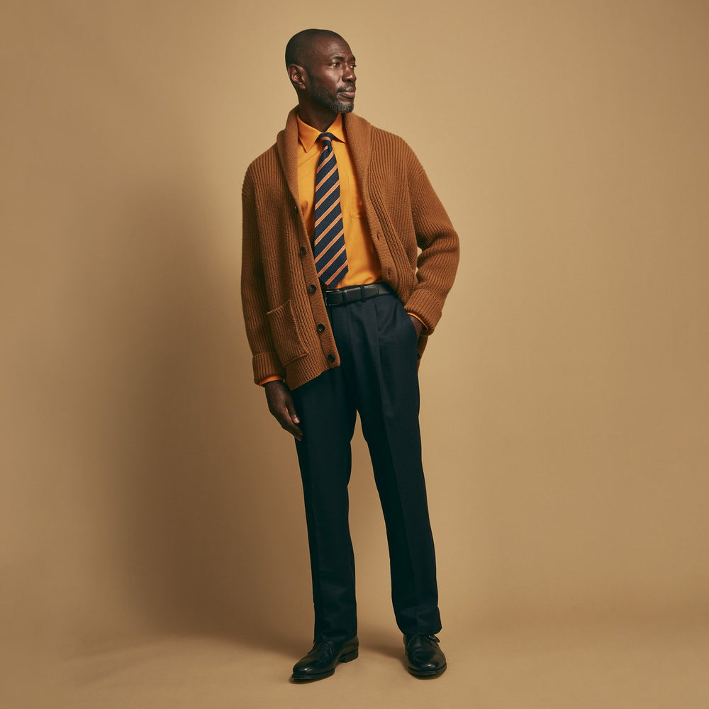 The Brown Ainsley Ribbed Shawl Cashmere Cardigan by Turnbull & Asser features a ribbed knit texture, black front buttons, and two front pockets, displayed laid flat on a white background.