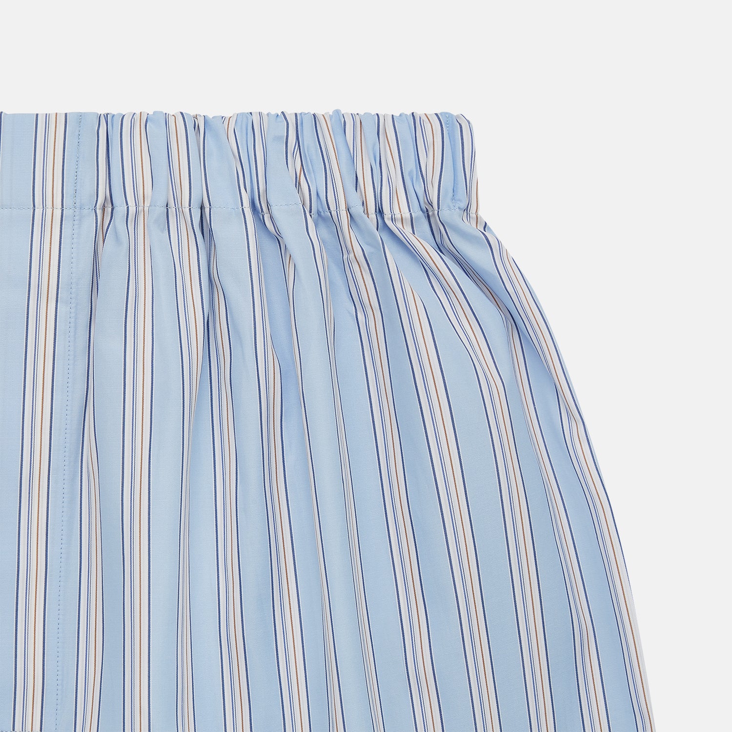 View 2 of product Turnbull & Asser Pale Blue Multi Striped Cotton Godfrey Boxer Shorts, featuring an elastic waistband and vertical white and navy stripes, laid flat on a plain white background.