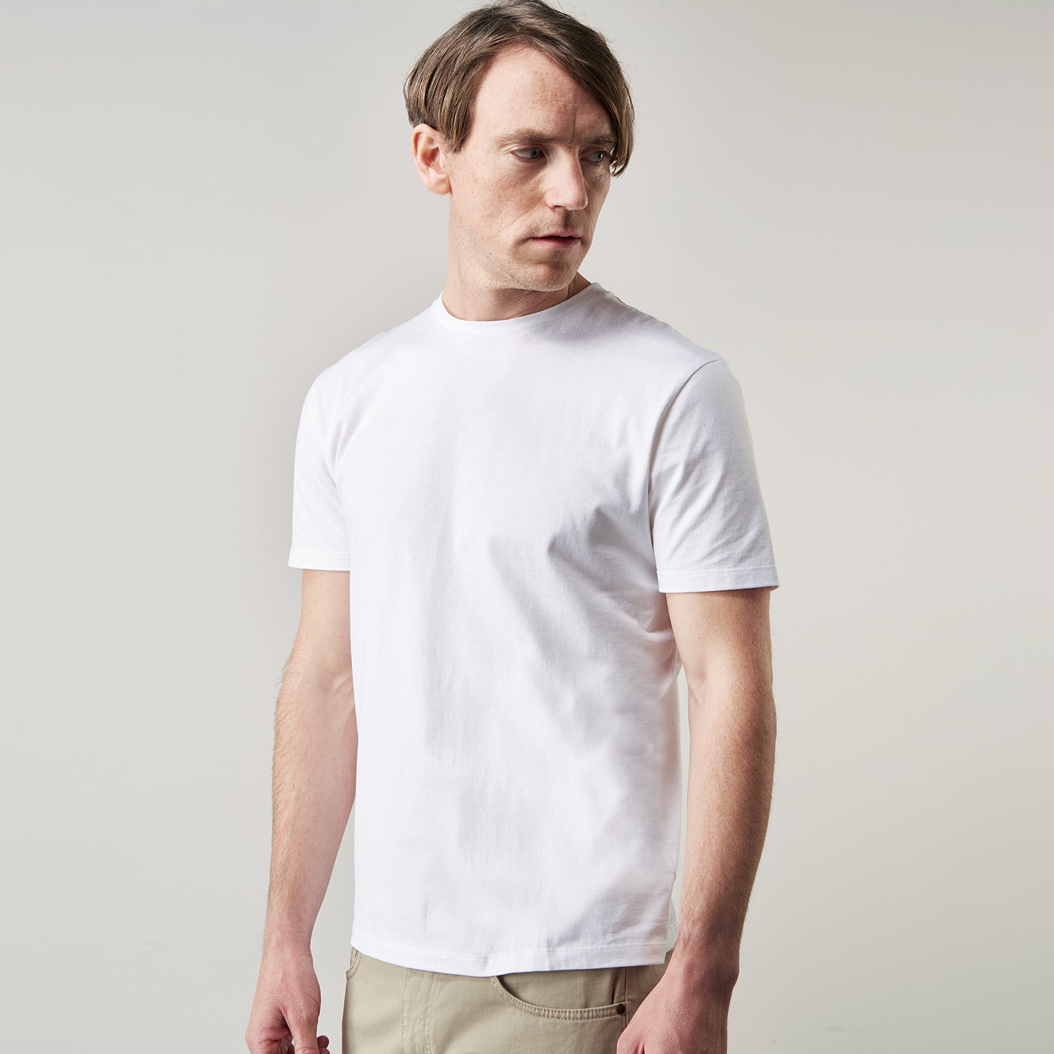View 2 of product The Turnbull & Asser White Davey Cotton T-Shirt is shown on a white background. Crafted from fine-gauge jersey, it features short sleeves, a classic crew neck, and a clean front with no visible logos or designs.