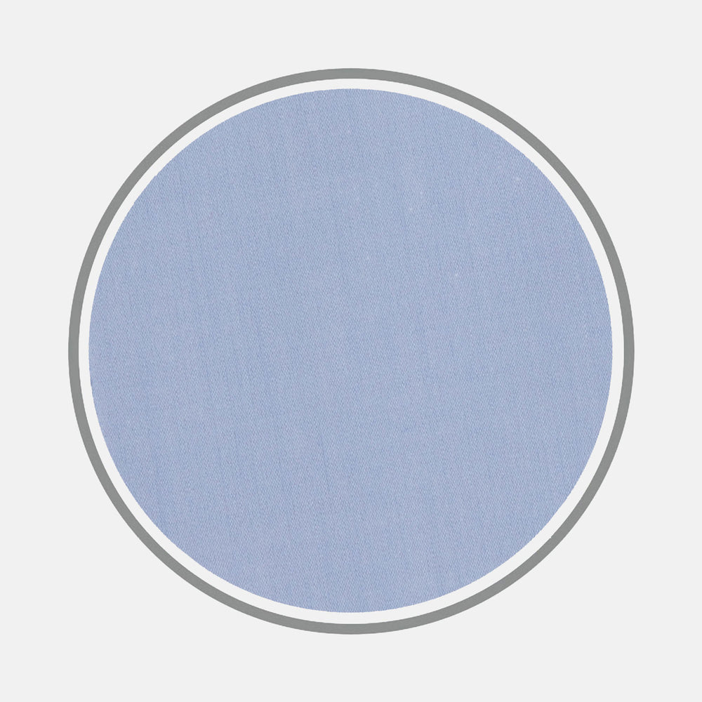 A circular swatch of Turnbull & Asser's Blue West Indian Sea Island Cotton Fabric with a smooth, finely woven texture is centered on a white background and outlined by thin gray and white borders.