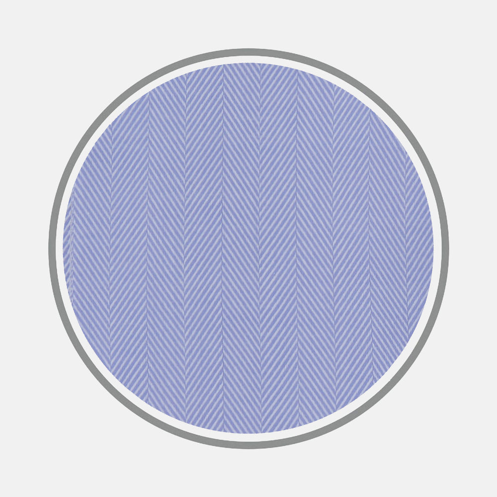 Turnbull & Asser's Blue Herringbone Sea Island Quality Cotton Fabric features thin light blue herringbone lines in a circular pattern on a darker blue background, encircled by gray and set against a plain light gray backdrop.