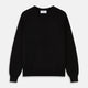 The Turnbull & Asser Black Crew Neck Cashmere Jumper is shown laid flat on a white background, featuring ribbed cuffs and hem with a small white label inside the collar.
