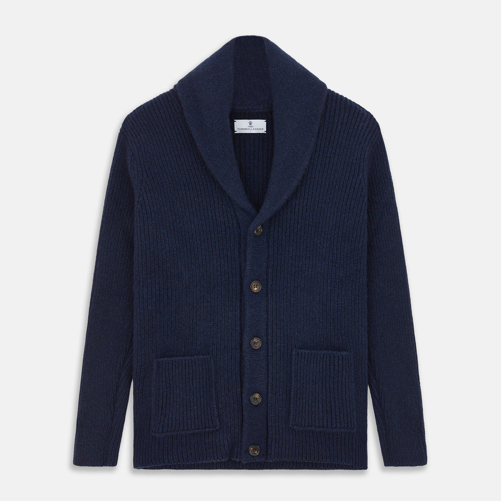 The Turnbull & Asser Navy Shawl Collar Cashmere Cardigan features a chunky knit, ribbed texture, button front, and two pockets—a luxurious piece laid flat on a white background for warmth and style.