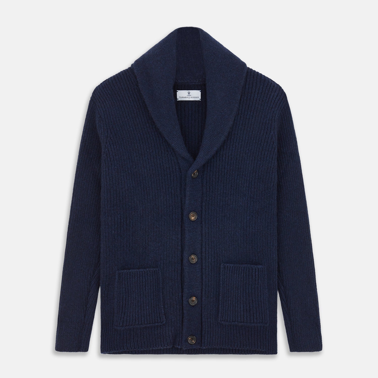 View 1 of product The Turnbull & Asser Navy Shawl Collar Cashmere Cardigan features a chunky knit, ribbed texture, button front, and two pockets—a luxurious piece laid flat on a white background for warmth and style.
