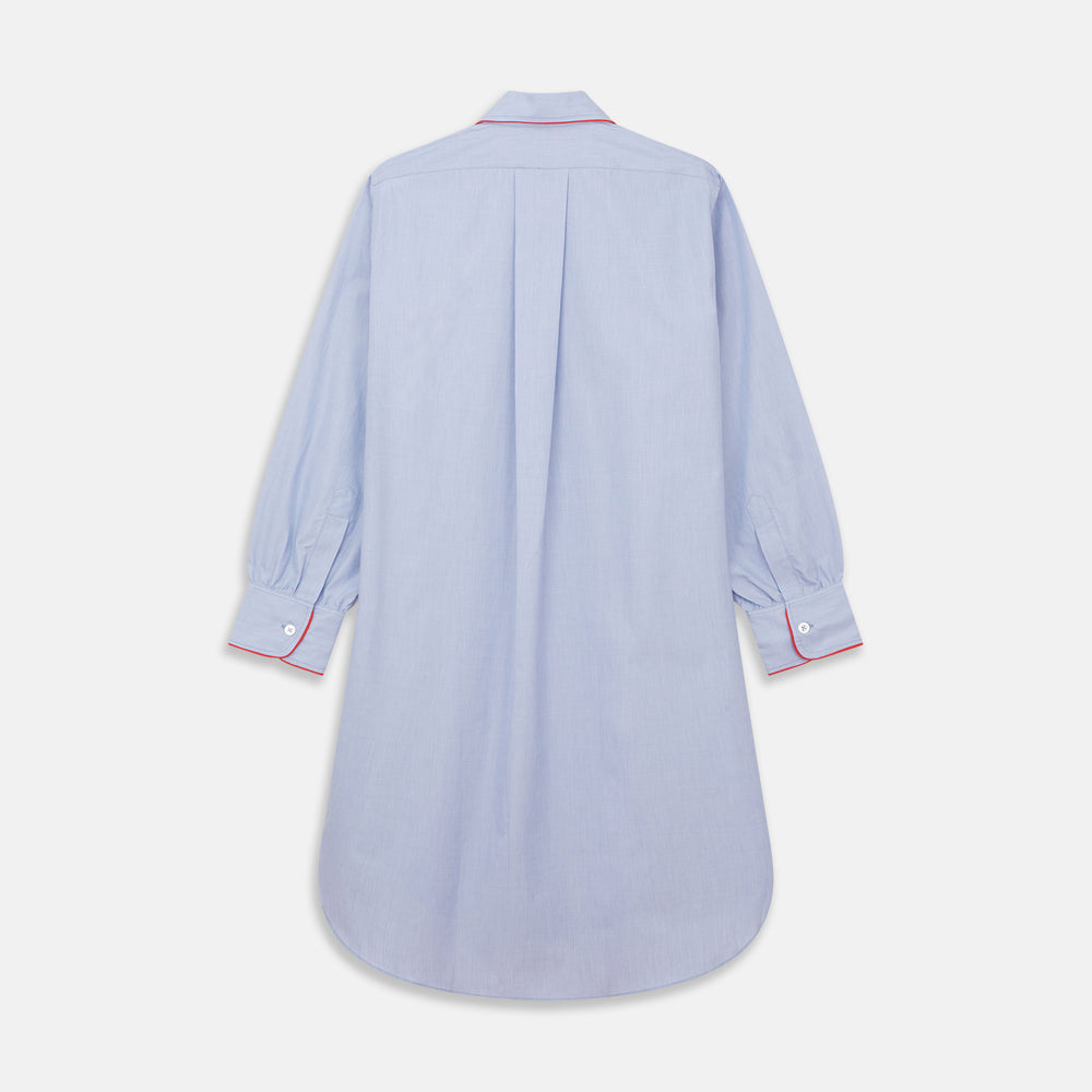 The Blue Piped End-on-End Cotton Nightshirt by Turnbull & Asser features light blue cotton, red piped accents, a chest pocket, high-low hem, and half-button placket—luxurious nightwear inspired by classic nightshirt style.