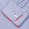 View 3 of product The Blue Piped End-on-End Cotton Nightshirt by Turnbull & Asser features light blue cotton, red piped accents, a chest pocket, high-low hem, and half-button placket—luxurious nightwear inspired by classic nightshirt style.
