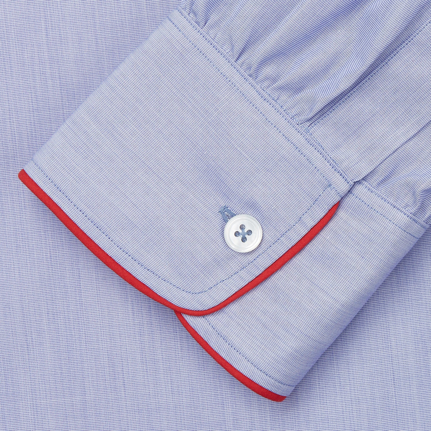 View 3 of product The Blue Piped End-on-End Cotton Nightshirt by Turnbull & Asser features light blue cotton, red piped accents, a chest pocket, high-low hem, and half-button placket—luxurious nightwear inspired by classic nightshirt style.