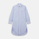 The Blue Piped End-on-End Cotton Nightshirt by Turnbull & Asser features light blue cotton, red piped accents, a chest pocket, high-low hem, and half-button placket—luxurious nightwear inspired by classic nightshirt style.