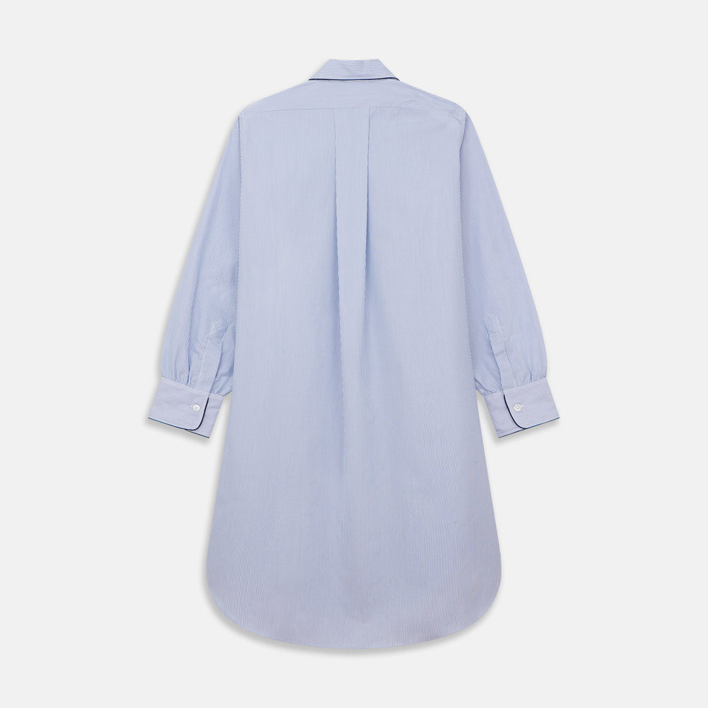 The Turnbull & Asser Blue Fine Bengal Stripe Piped Cotton Nightshirt features long sleeves, a chest pocket, black collar piping, curved hem, and side slits. It is displayed laid flat on a white background.