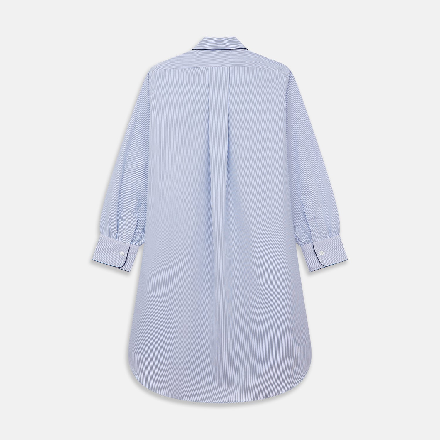 View 5 of product The Turnbull & Asser Blue Fine Bengal Stripe Piped Cotton Nightshirt features long sleeves, a chest pocket, black collar piping, curved hem, and side slits. It is displayed laid flat on a white background.