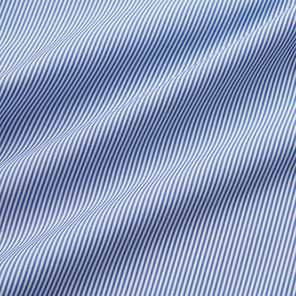 The Turnbull & Asser Blue Fine Bengal Stripe Piped Cotton Nightshirt features long sleeves, a chest pocket, black collar piping, curved hem, and side slits. It is displayed laid flat on a white background.