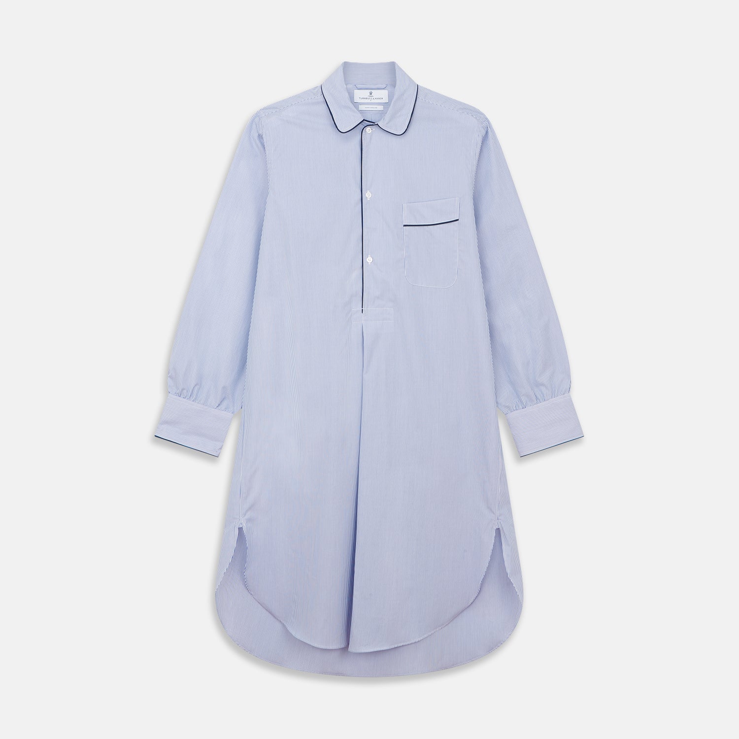 View 1 of product The Turnbull & Asser Blue Fine Bengal Stripe Piped Cotton Nightshirt features long sleeves, a chest pocket, black collar piping, curved hem, and side slits. It is displayed laid flat on a white background.