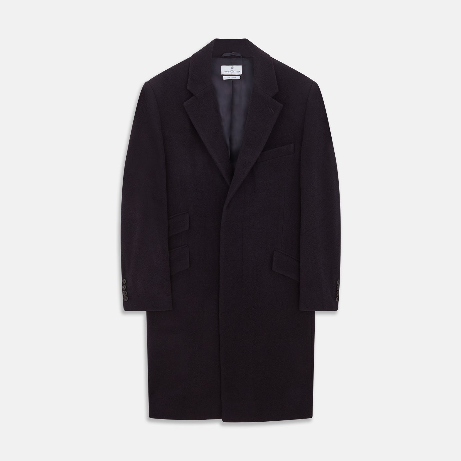View 1 of product The Turnbull & Asser Navy Cashmere Joseph Overcoat features notched lapels, three front pockets, buttoned cuffs, and a hidden button closure—an essential men’s outerwear piece shown against a plain white background.