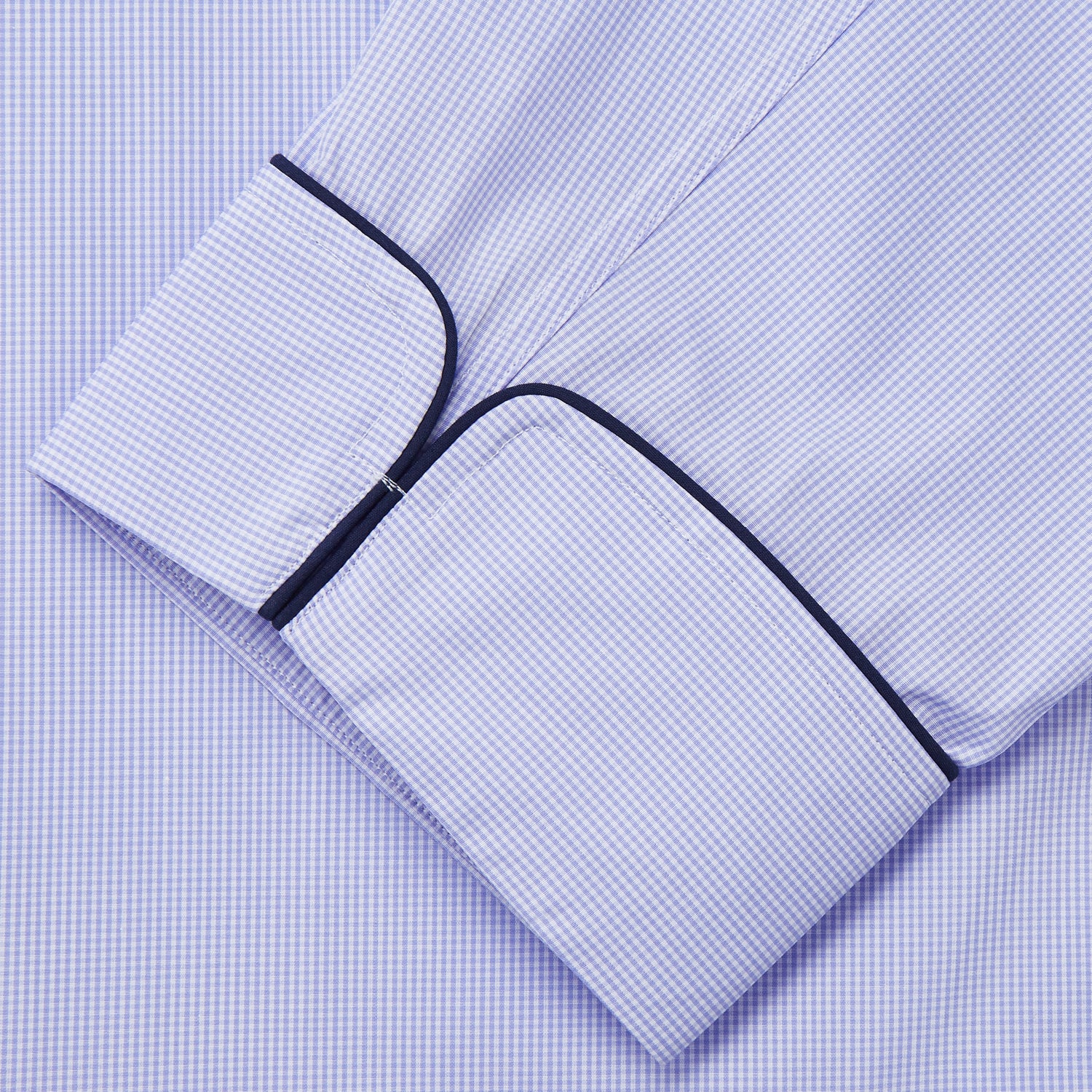 View 3 of product Turnbull & Asser's Blue Fine Check Piped Sea Island Quality Cotton Pyjama Set features white buttons, black piping on the collar, cuffs, and pocket, with matching drawstring pants—displayed flat on a white background.
