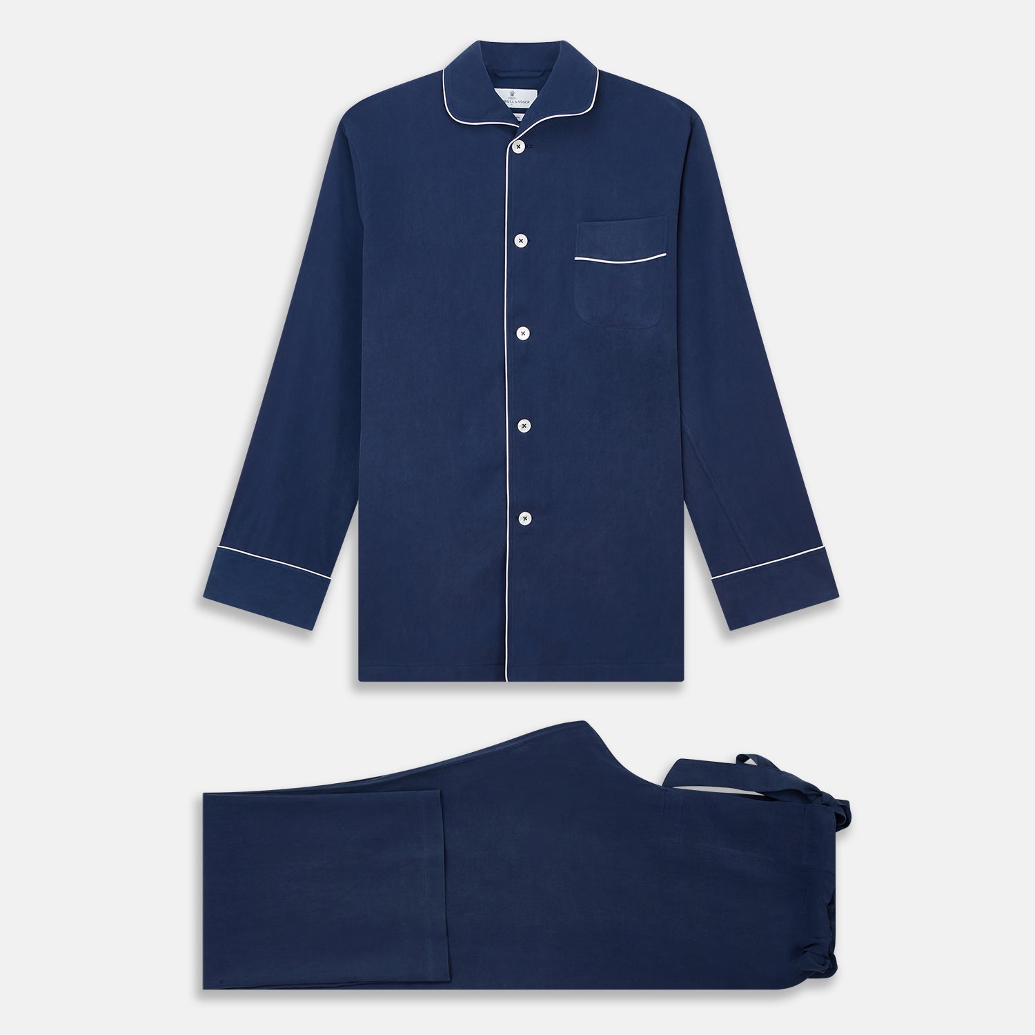 View 2 of product The Turnbull & Asser Navy Piped Silk Pyjama Set features a long-sleeve button-up top with a chest pocket and matching drawstring pants, laid flat on a white background for a luxurious look.