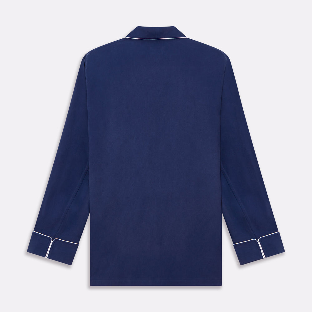 The Turnbull & Asser Navy Piped Silk Pyjama Set features a long-sleeve button-up top with a chest pocket and matching drawstring pants, laid flat on a white background for a luxurious look.
