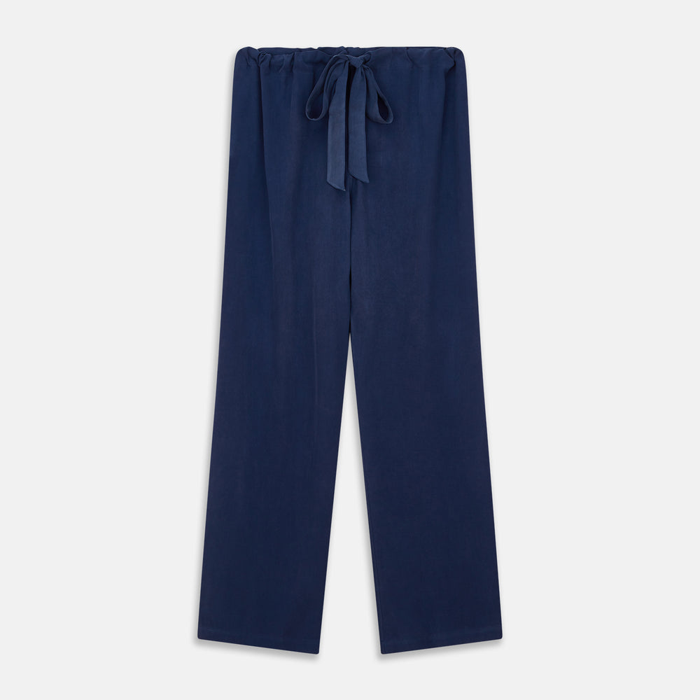 The Turnbull & Asser Navy Piped Silk Pyjama Set features a long-sleeve button-up top with a chest pocket and matching drawstring pants, laid flat on a white background for a luxurious look.