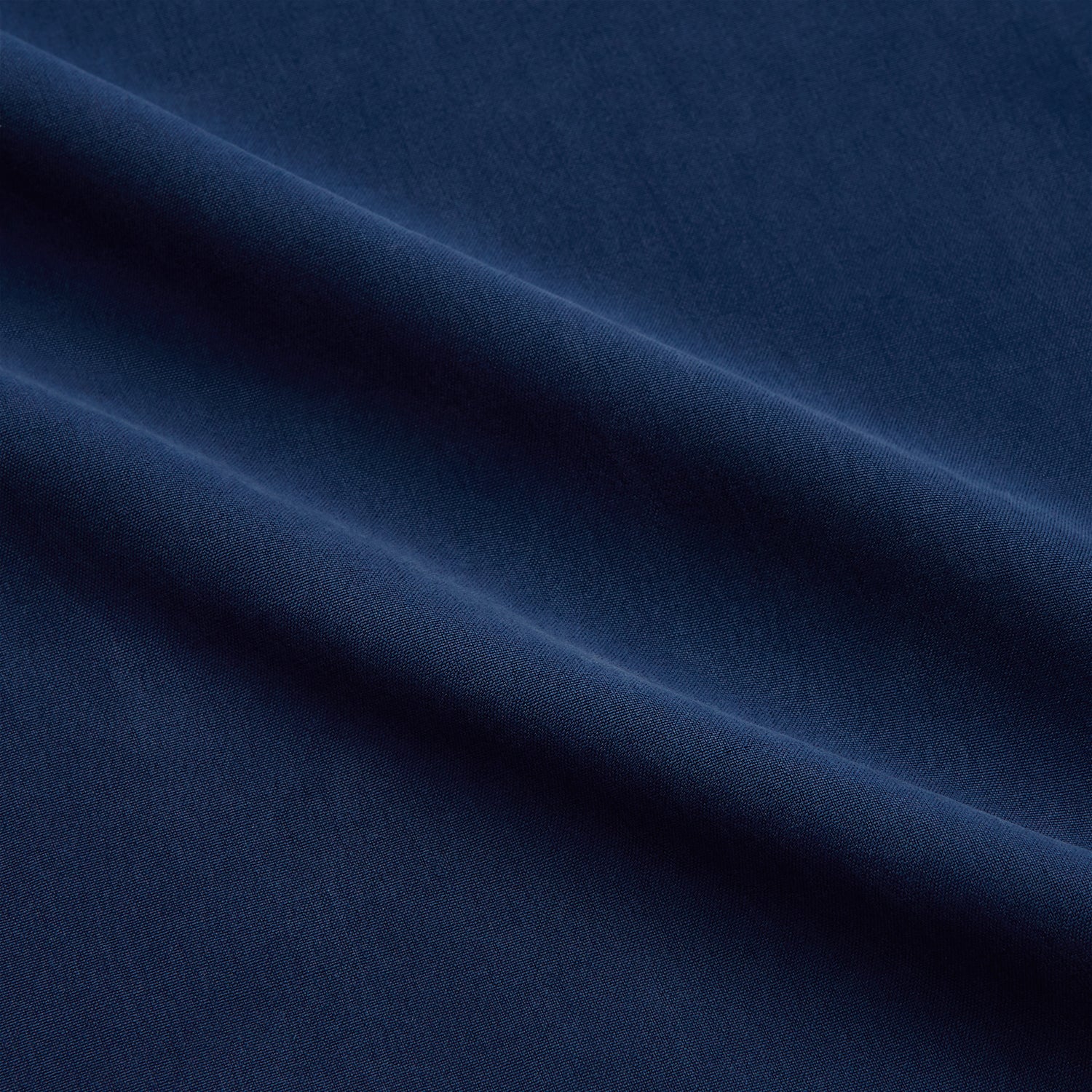 View 5 of product The Turnbull & Asser Navy Piped Silk Pyjama Set features a long-sleeve button-up top with a chest pocket and matching drawstring pants, laid flat on a white background for a luxurious look.